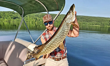 A proud angler shows off a massive muskie caught from his LiTime-powered boat