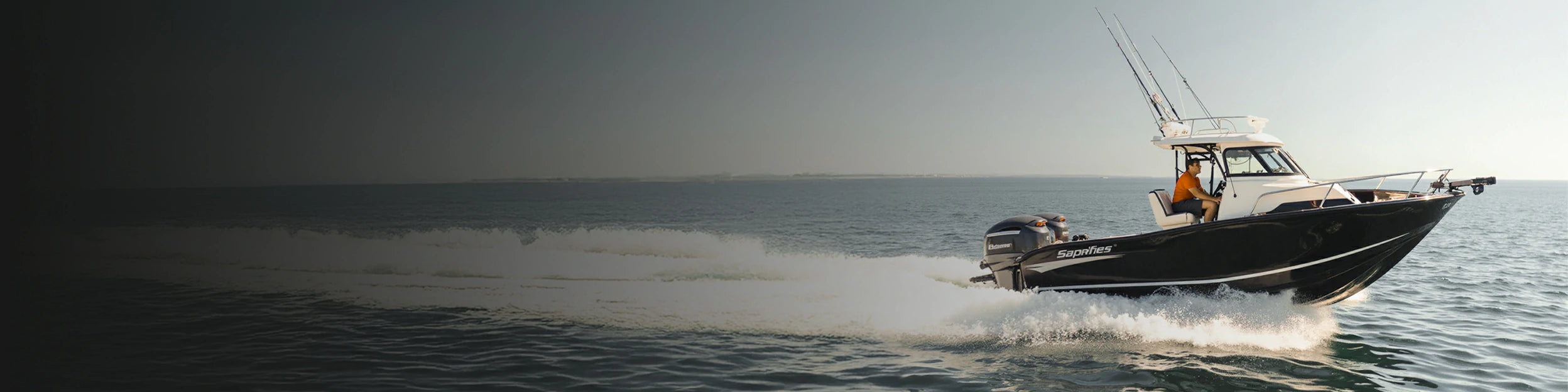 A cabin boat cruising on the water, representing powered by reliable trollling motor battery system