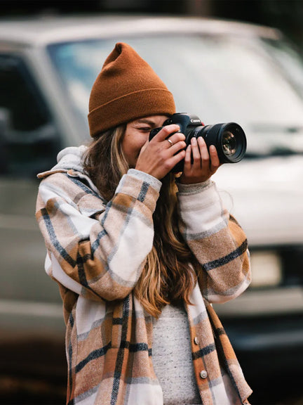 A woman with a professional camera, representing the LiTime blog and user adventure stories